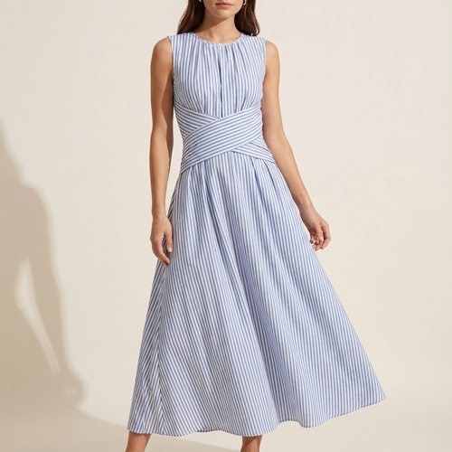 Woman wearing a blue and white striped dress on a beige background