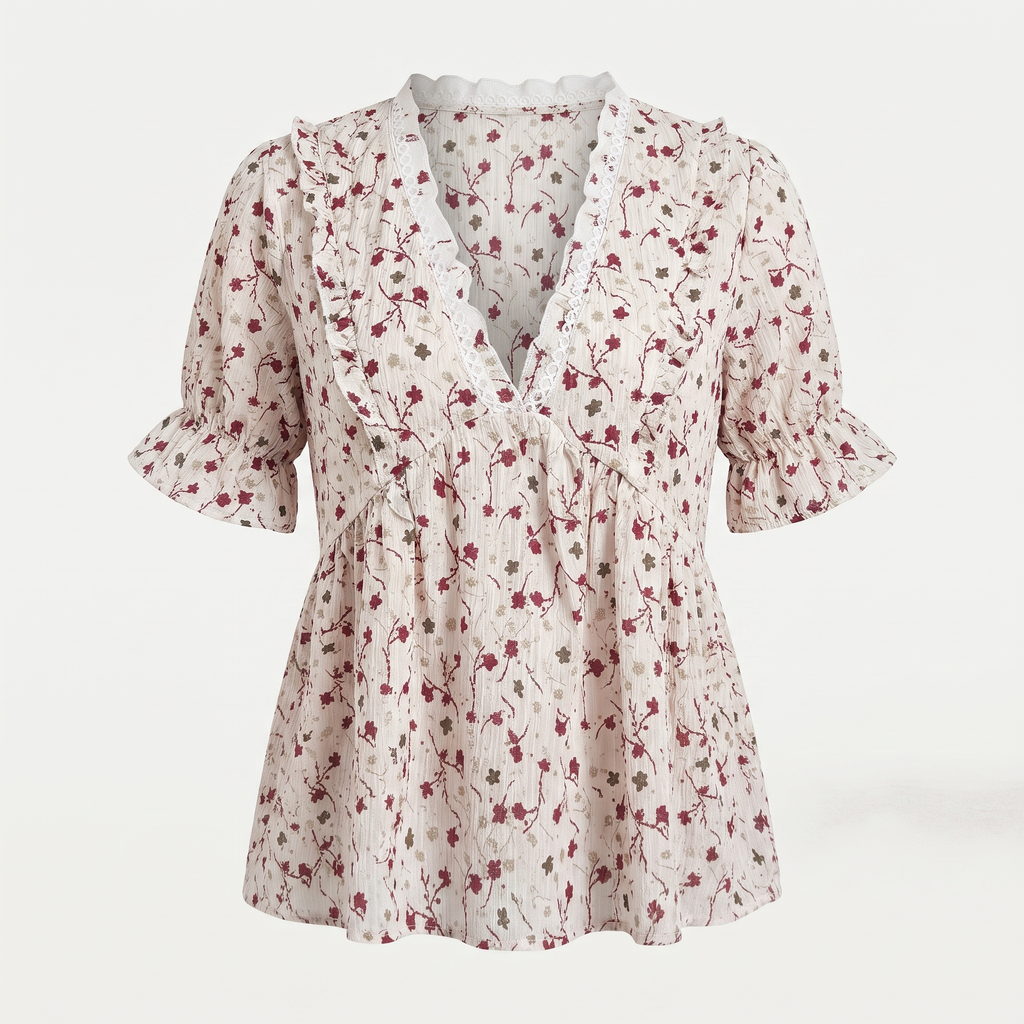 A short-sleeve floral blouse with a ruffled V-neckline, peplum waist, and ruffled sleeves, shown against a plain light background.