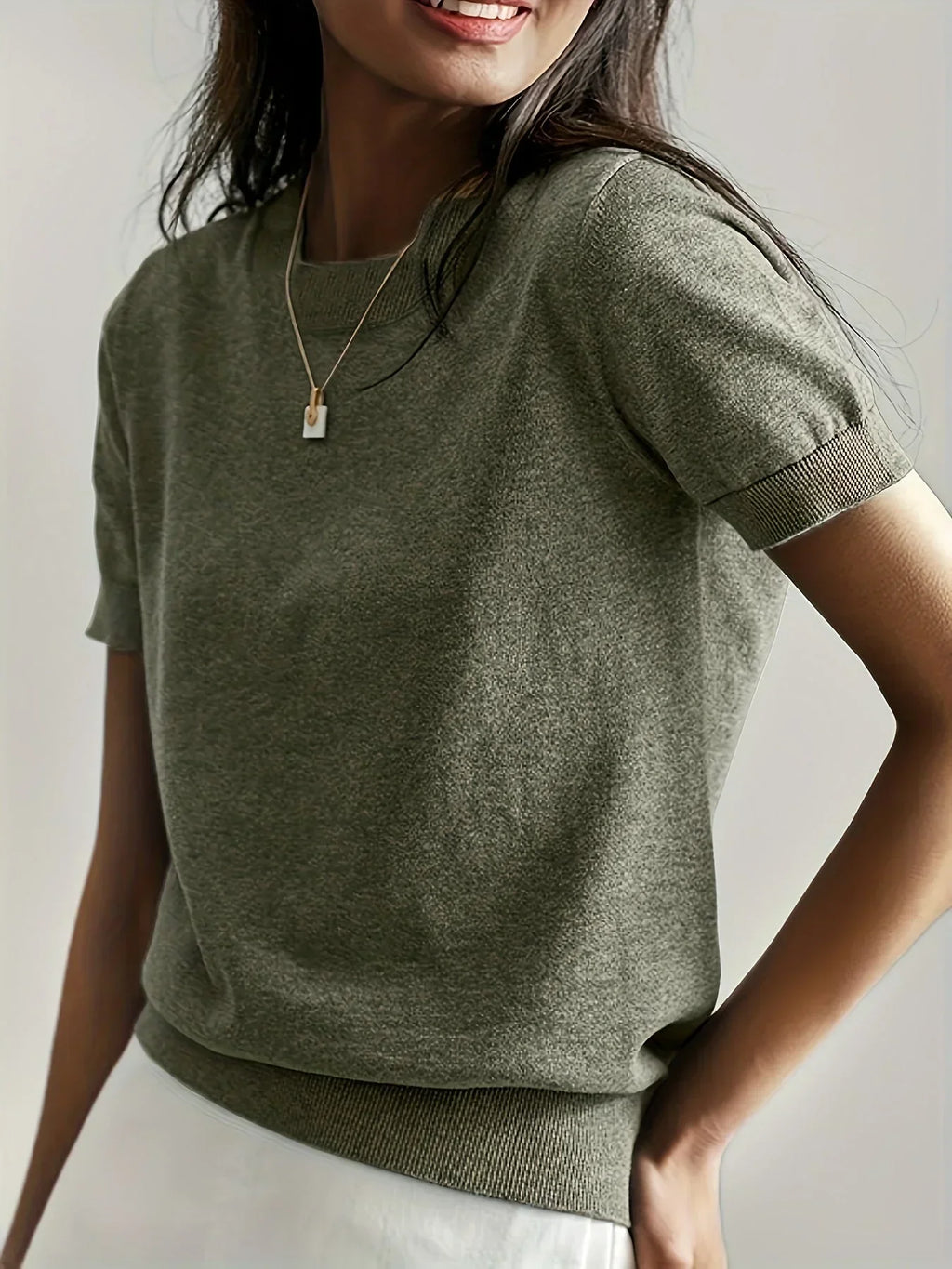 Olive green fine knit short sleeve sweater with a crew neck and ribbed trim details.