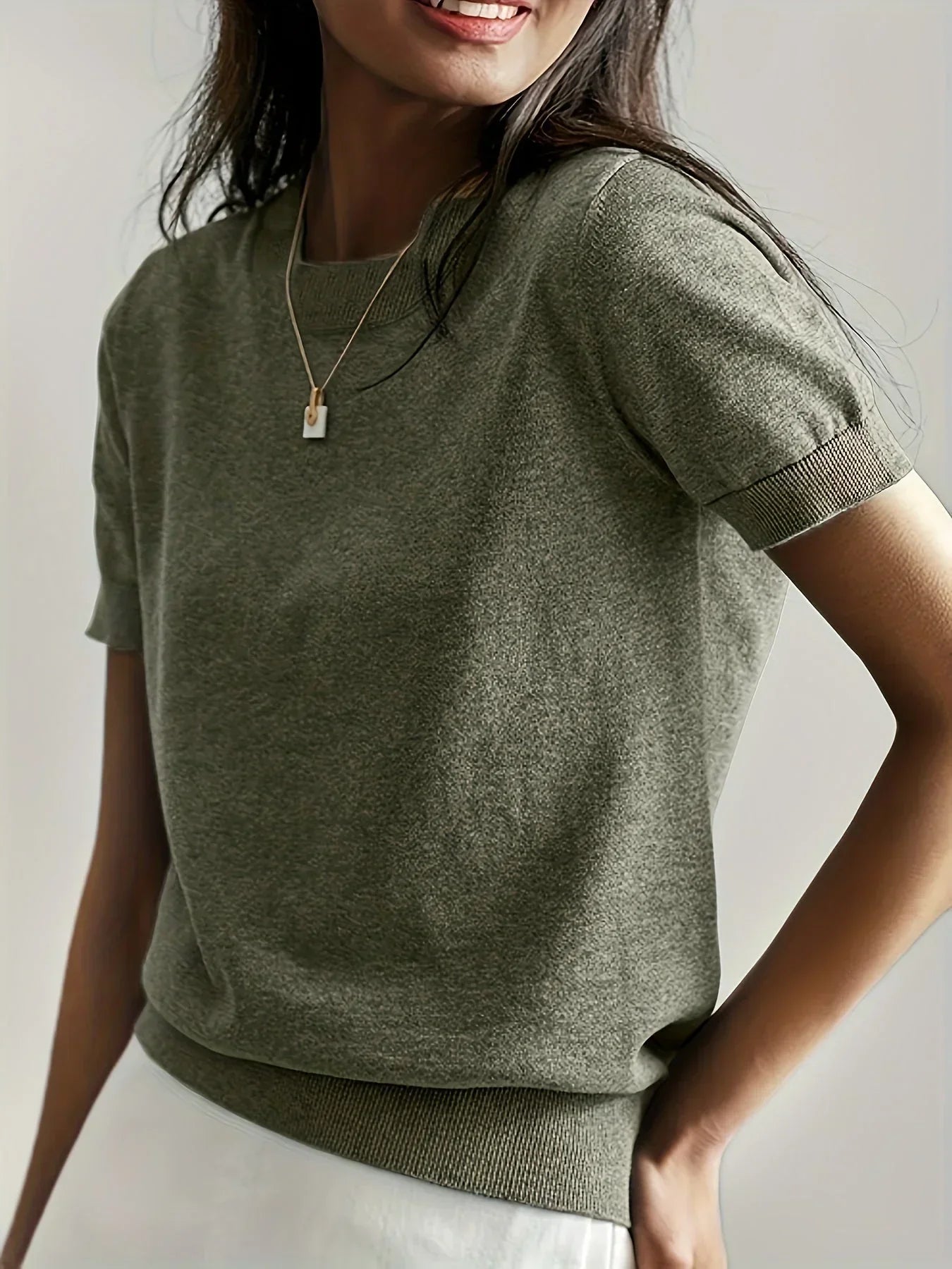 Olive green fine knit short sleeve sweater with a crew neck and ribbed trim details.