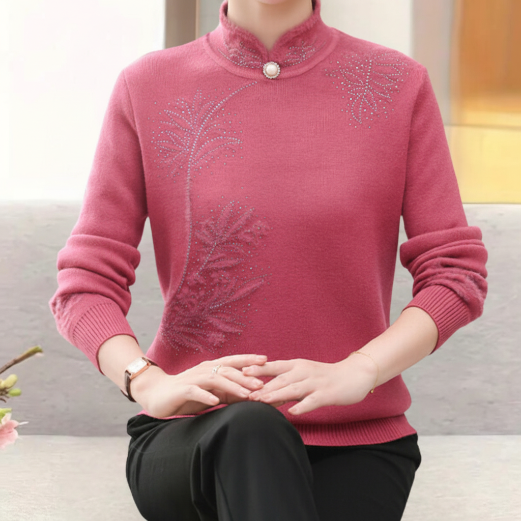 Fitted pink long-sleeve sweater with a high mandarin collar, single button detail, and delicate crystal leaf accents.