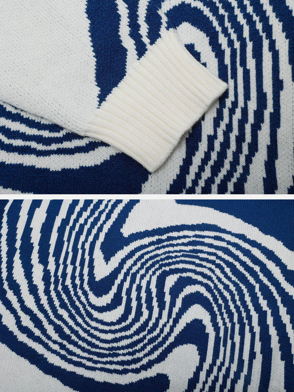 Soft white and blue knitted pullover sweater featuring a detailed abstract swirl pattern and ribbed cuff detail.