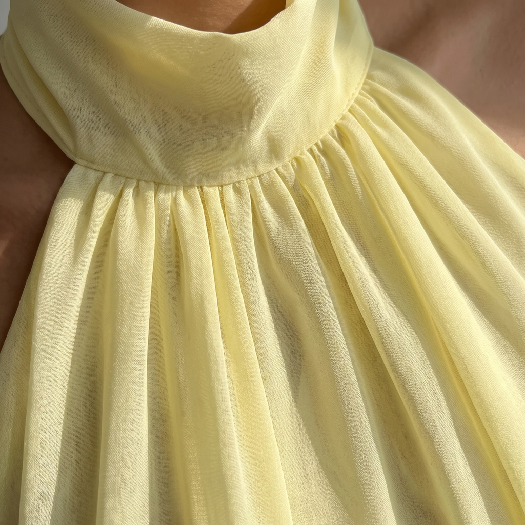 Close-up of a yellow dress with a focus on the fabric texture.