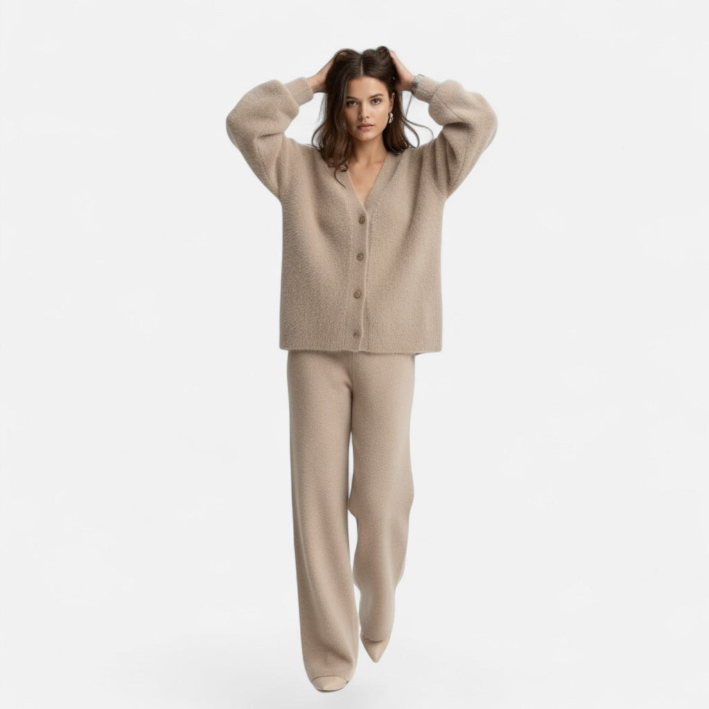 Woman wearing a beige loose-fit V-neck buttoned knit cardigan and matching wide-leg knit trousers.