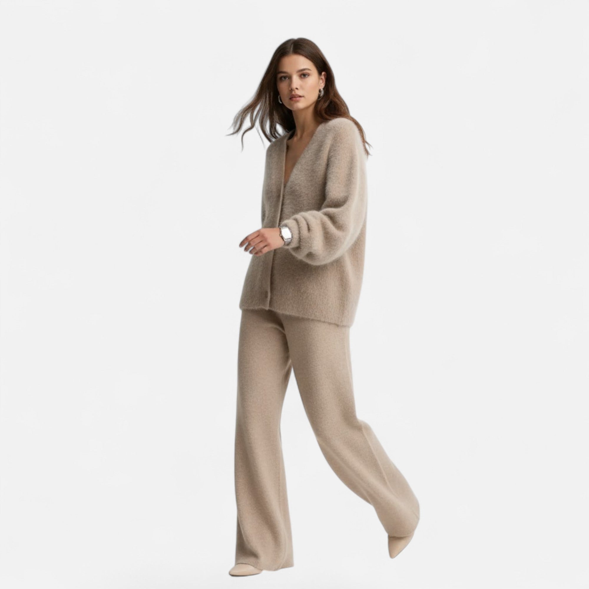 Woman wearing a beige loose-fit V-neck buttoned knit cardigan and matching wide-leg trousers against a white background.