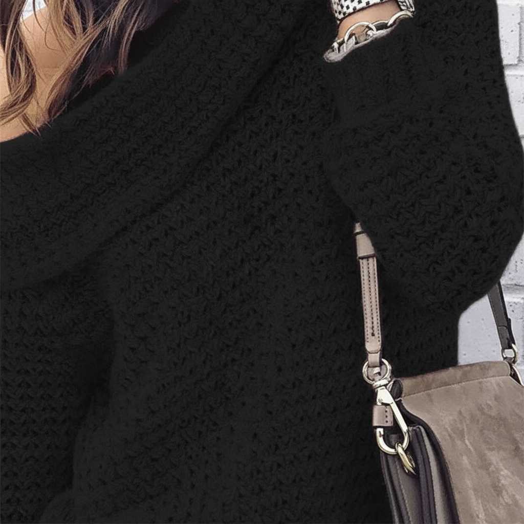 Black long-sleeve off-shoulder sweater featuring a textured open knit design and a relaxed, folded neckline.