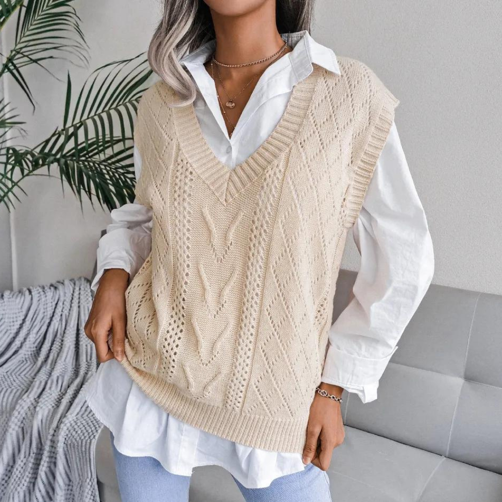 Beige openwork ribbed V-neck sweater vest layered over a white button-down shirt.