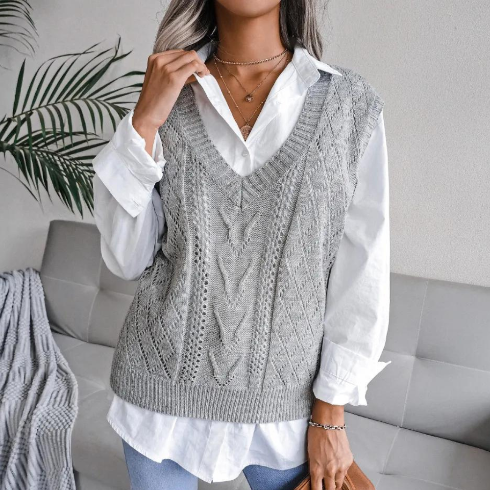 Grey openwork ribbed V-neck sweater vest layered over a white button-down shirt.