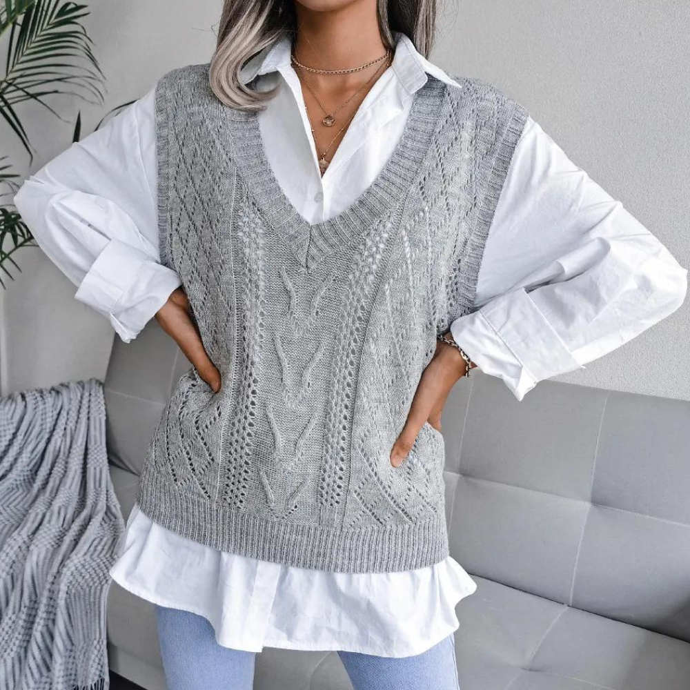 Grey openwork ribbed V-neck sweater vest layered over a white button-down shirt.