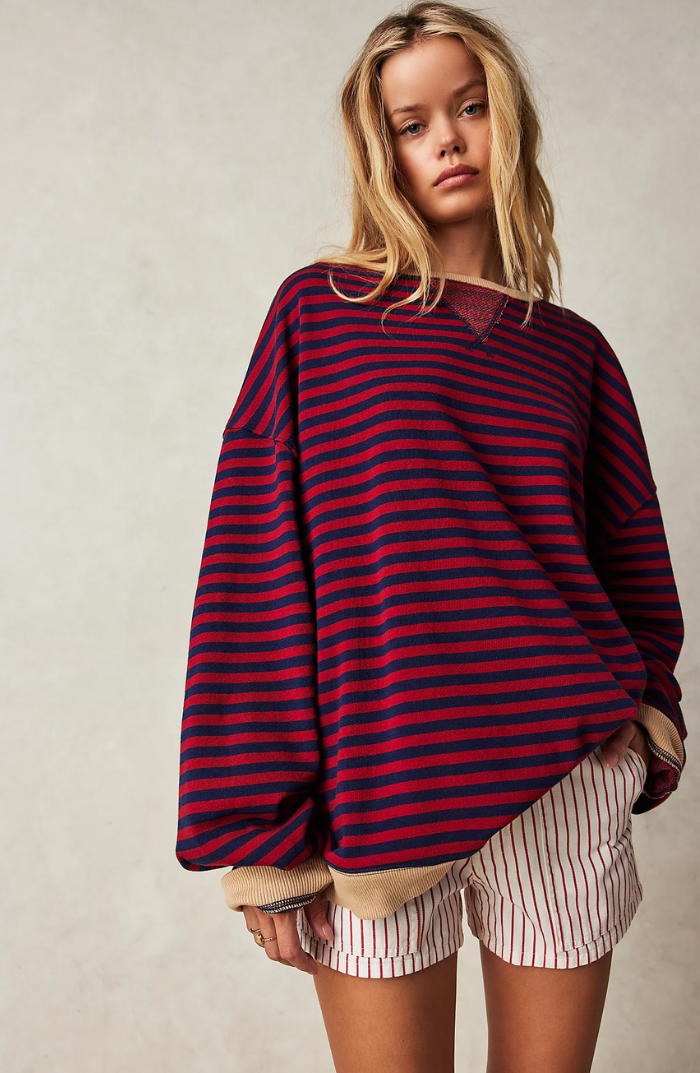 Oversized red and navy striped sweatshirt with balloon sleeves and ribbed tan trim worn by a blonde woman.