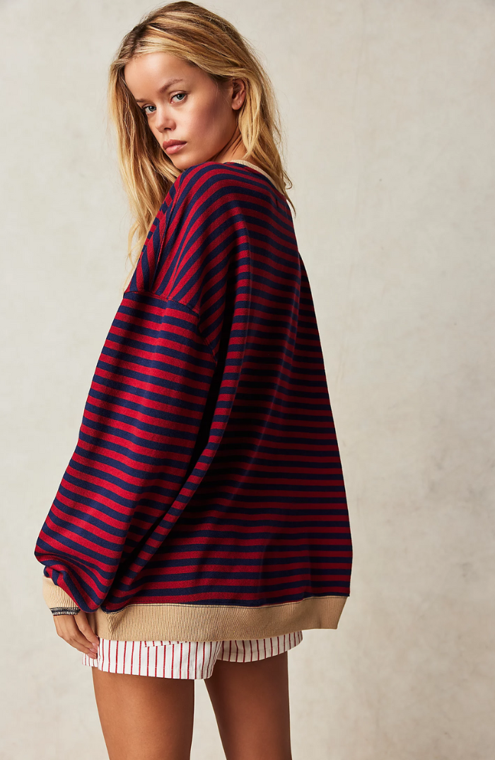 Oversized navy and red striped sweatshirt with balloon sleeves and a tan ribbed hem worn by a blonde woman.