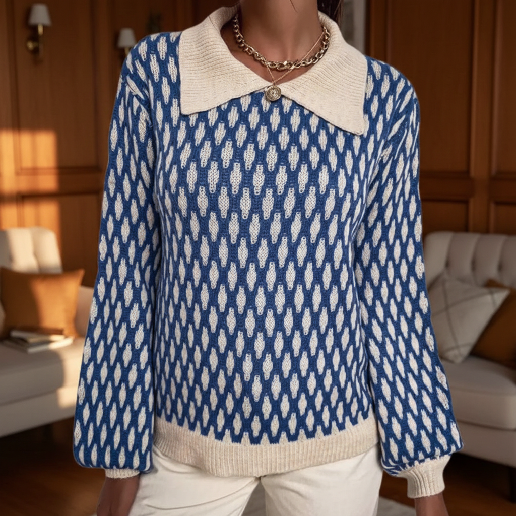 Blue and white printed ribbed knit sweater with a broad pointed collar and long sleeves.