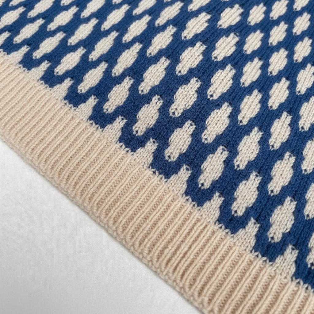 Blue and cream printed ribbed knit sweater with a textured geometric pattern and a solid ribbed hem.