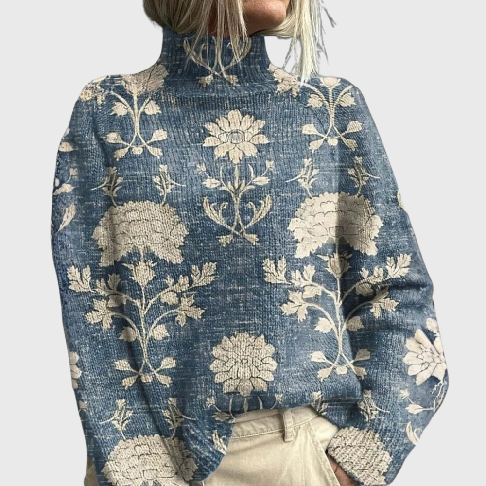 Blue turtleneck sweater with a floral print, ribbed knit texture, and relaxed long-sleeve fit.