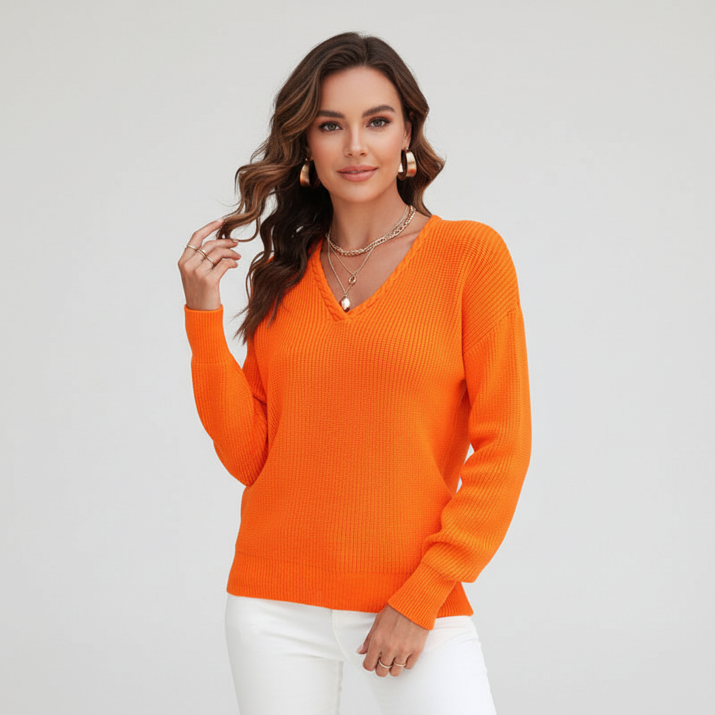 Woman wearing a bright orange ribbed V-neck sweater with dropped shoulders and a relaxed fit against a white background.