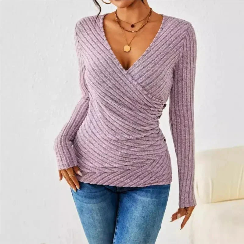 Lavender ribbed long-sleeve wrap top with V-neck and side button detail worn with blue jeans.