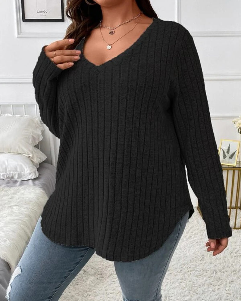 Black ribbed V-neck jumper with long sleeves in a soft cotton blend, styled with casual jeans for a relaxed fit.