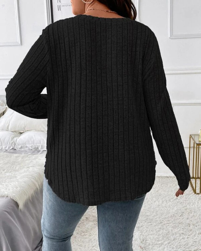 Back view of a black ribbed long-sleeve jumper with a soft cotton blend, worn with blue jeans in a casual bedroom setting.