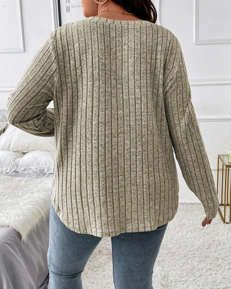 Back view of a sage green ribbed long-sleeve V-neck jumper in a soft cotton blend, styled with casual blue jeans.