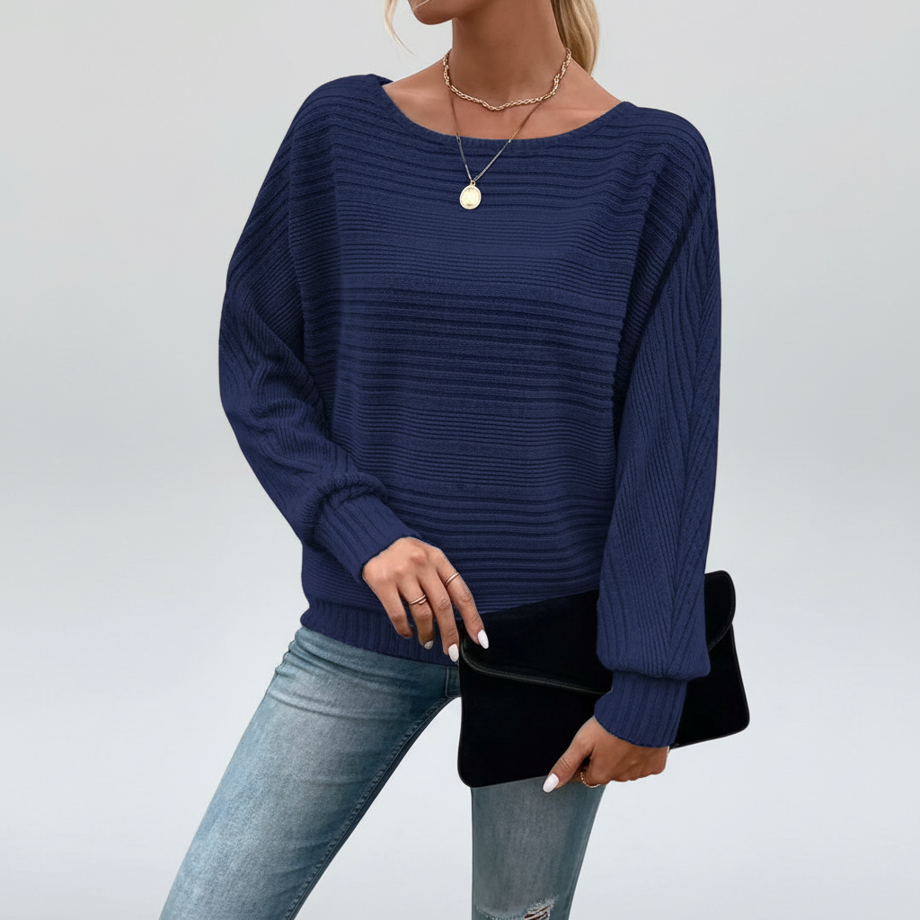Navy blue textured knit sweater with a wide round neckline and relaxed batwing sleeves, featuring ribbed cuffs and hem.