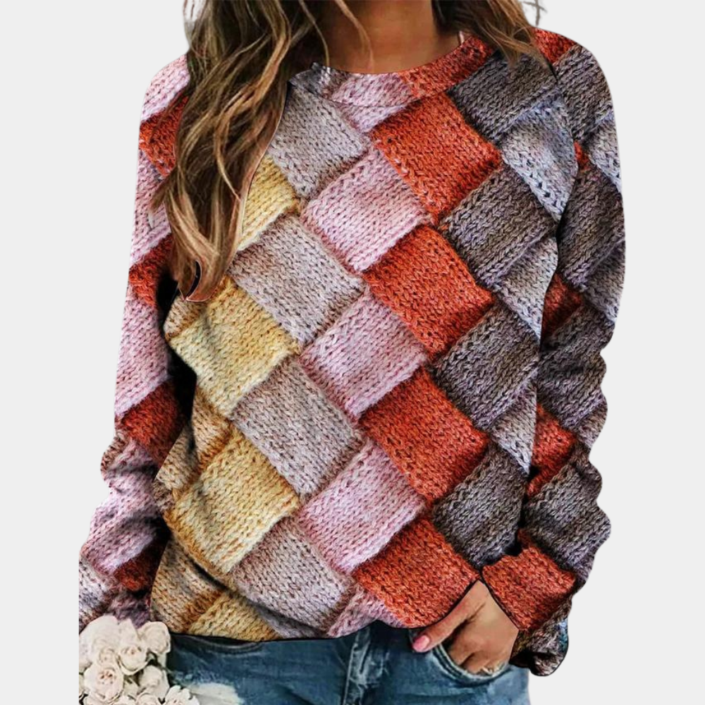 Relaxed raglan sweater featuring a multicolored diamond-patterned knit texture and a classic round neckline.