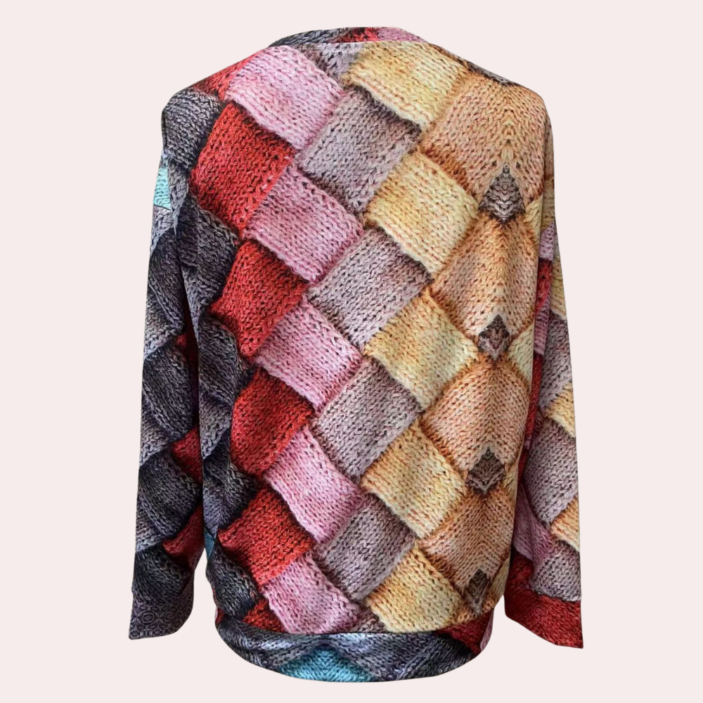 Relaxed raglan sweater featuring a multicolored, textured knit pattern with a round neckline and long sleeves.