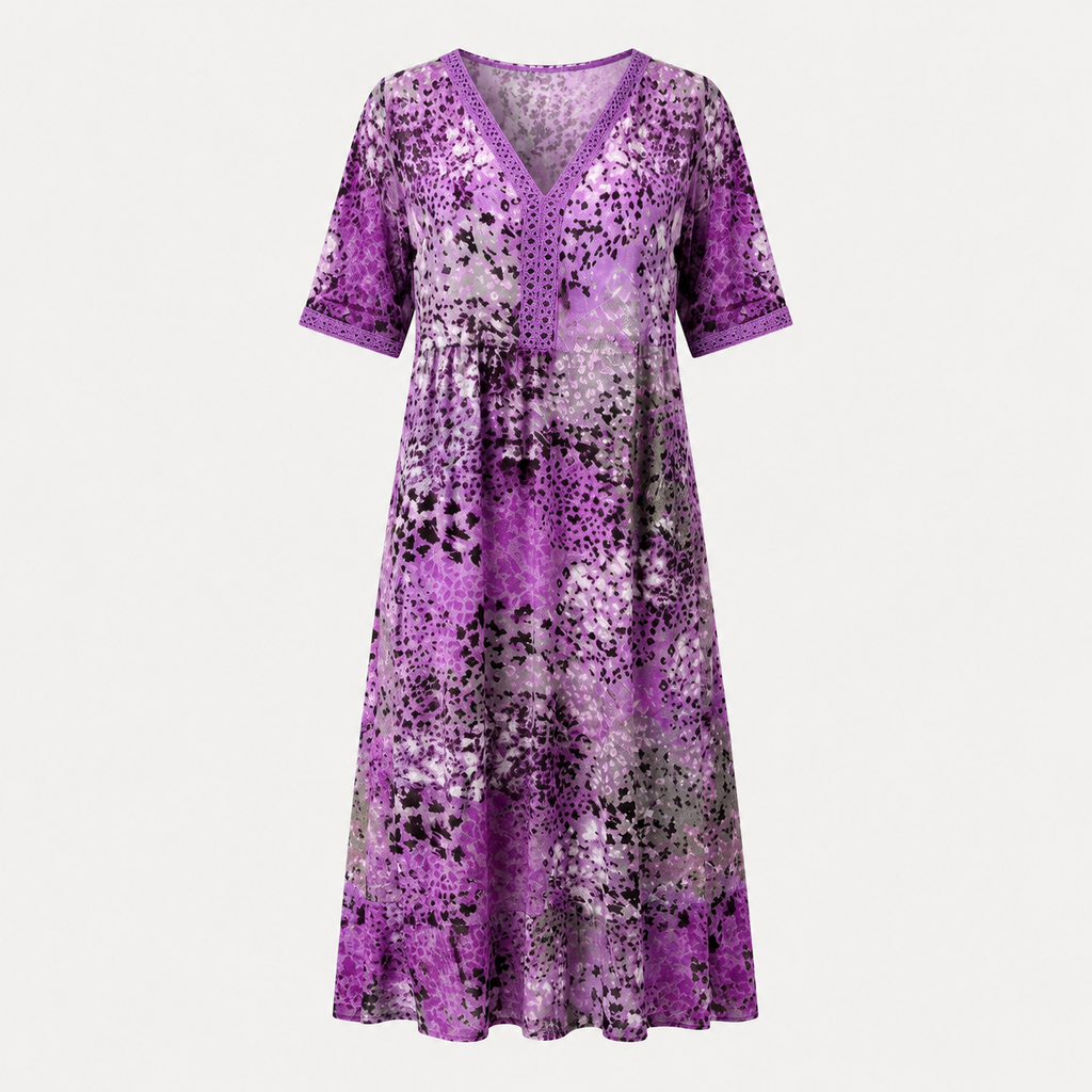 A purple short-sleeve V-neck dress with an abstract floral pattern in shades of purple, pink, and black, shown against a light gray background.