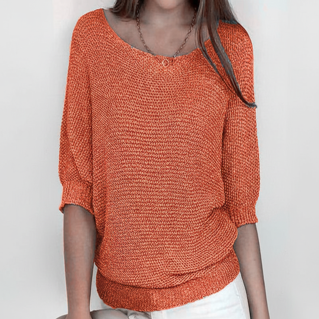 Relaxed orange dolman sleeve sweater with a wide neckline, textured knit fabric, and ribbed cuffs and hem.