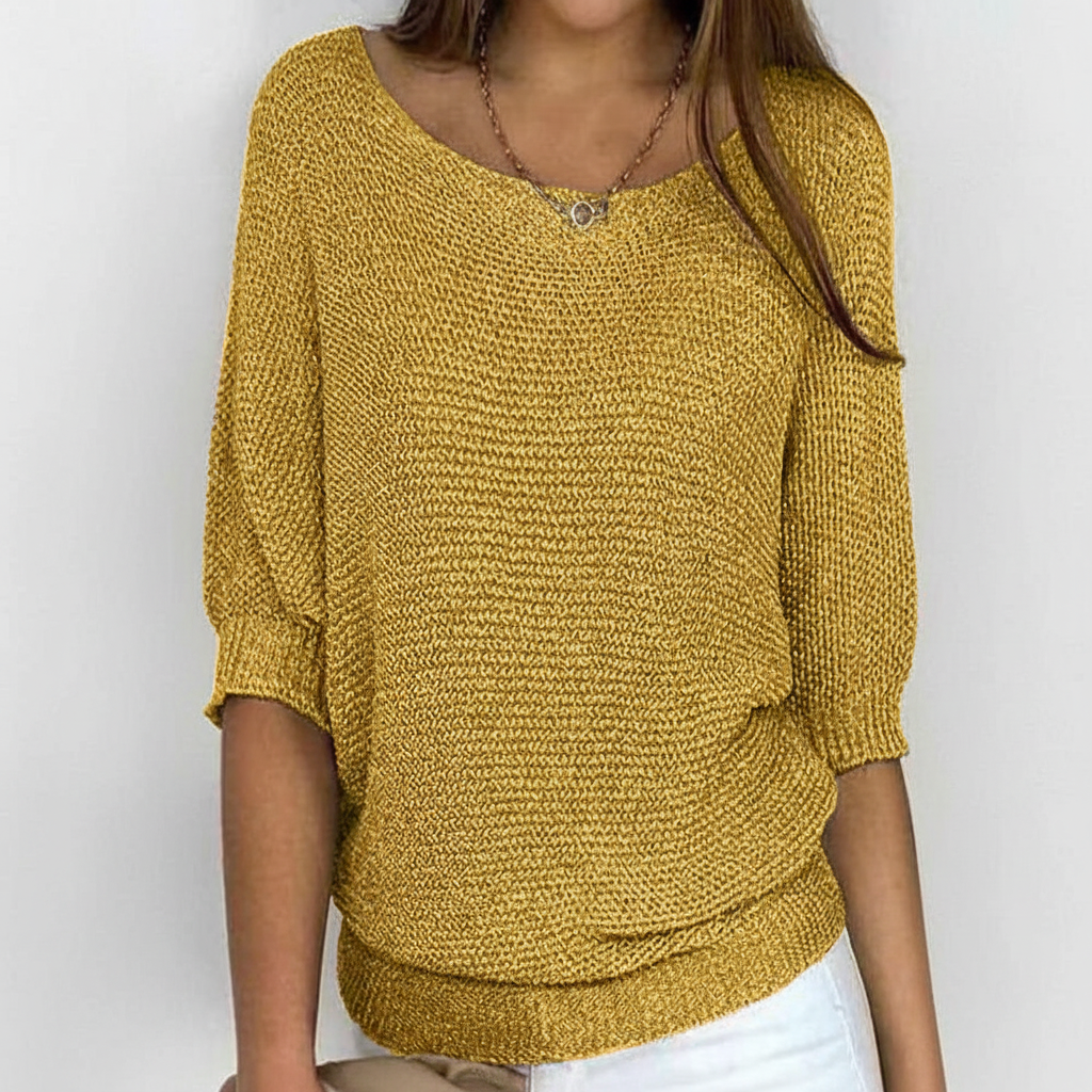 Mustard yellow relaxed sweater with a wide neckline, dolman sleeves, and a ribbed hem.