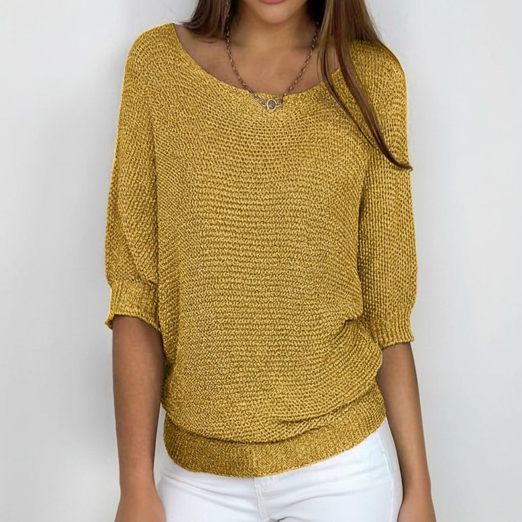 Mustard yellow relaxed-fit sweater with wide neckline, dolman sleeves, and ribbed hem.