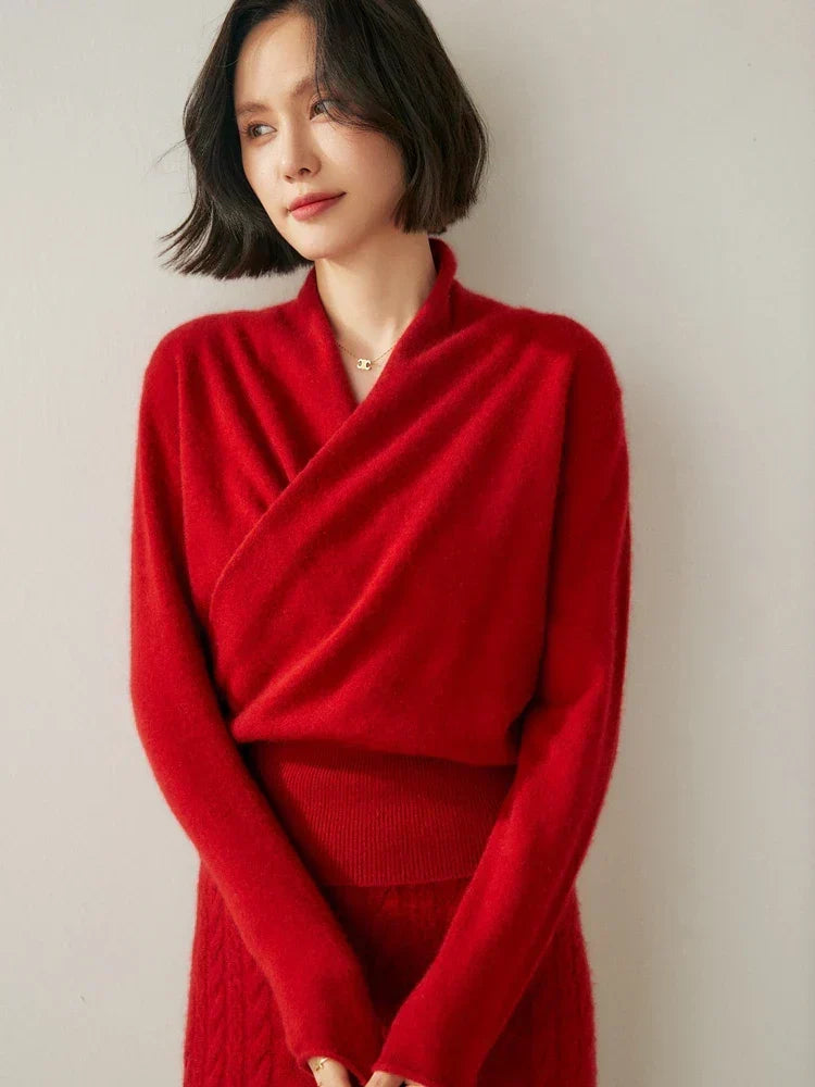 Red slim-fit knit sweater featuring a feminine crossover wrap neckline and long sleeves with a ribbed hem.