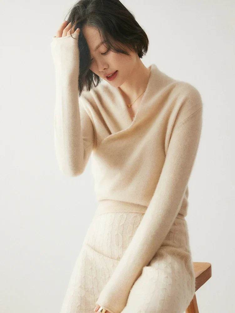 Slim-fit white knit sweater featuring a feminine wrap-style crossover neckline and long sleeves with ribbed cuffs.