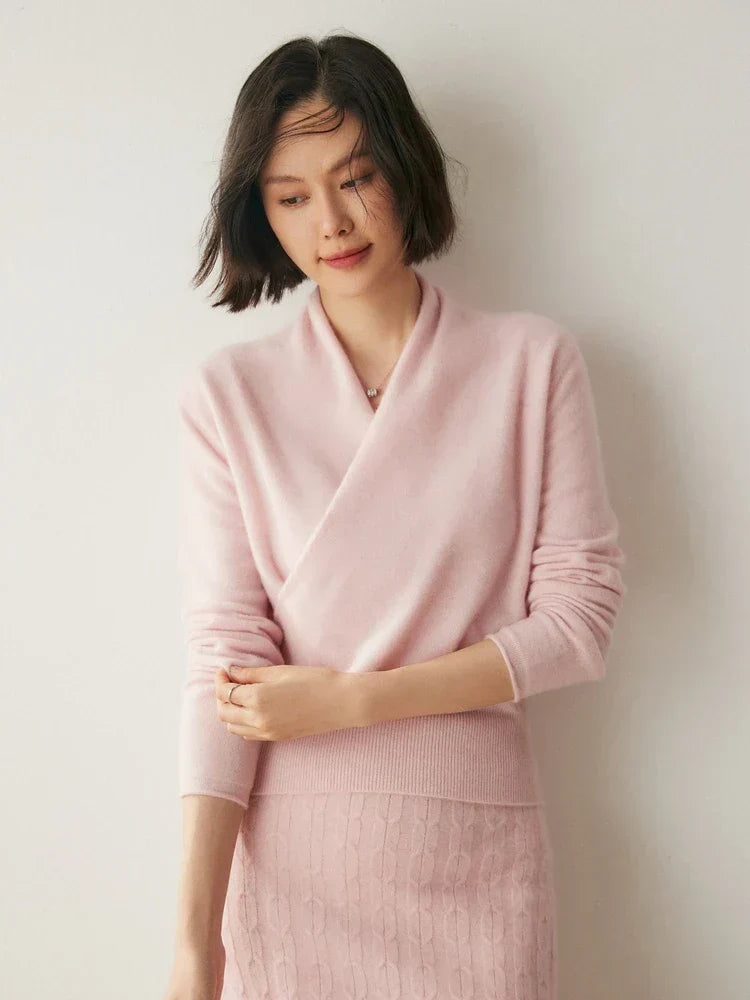 Slim-fit pink knit sweater featuring a crossover wrap neckline and long sleeves with ribbed cuffs.