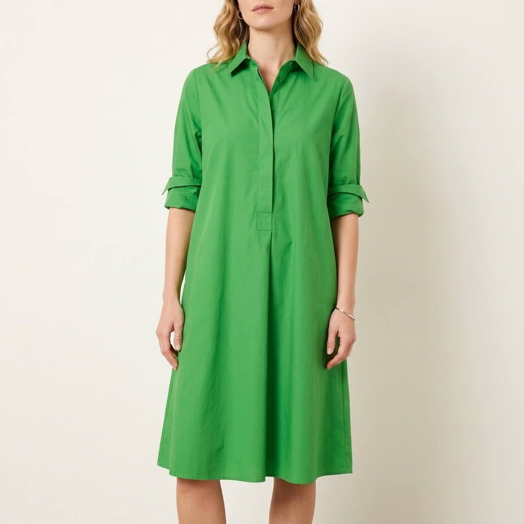 Woman wearing a green collared shirt dress with a waist-height button placket, front studio view