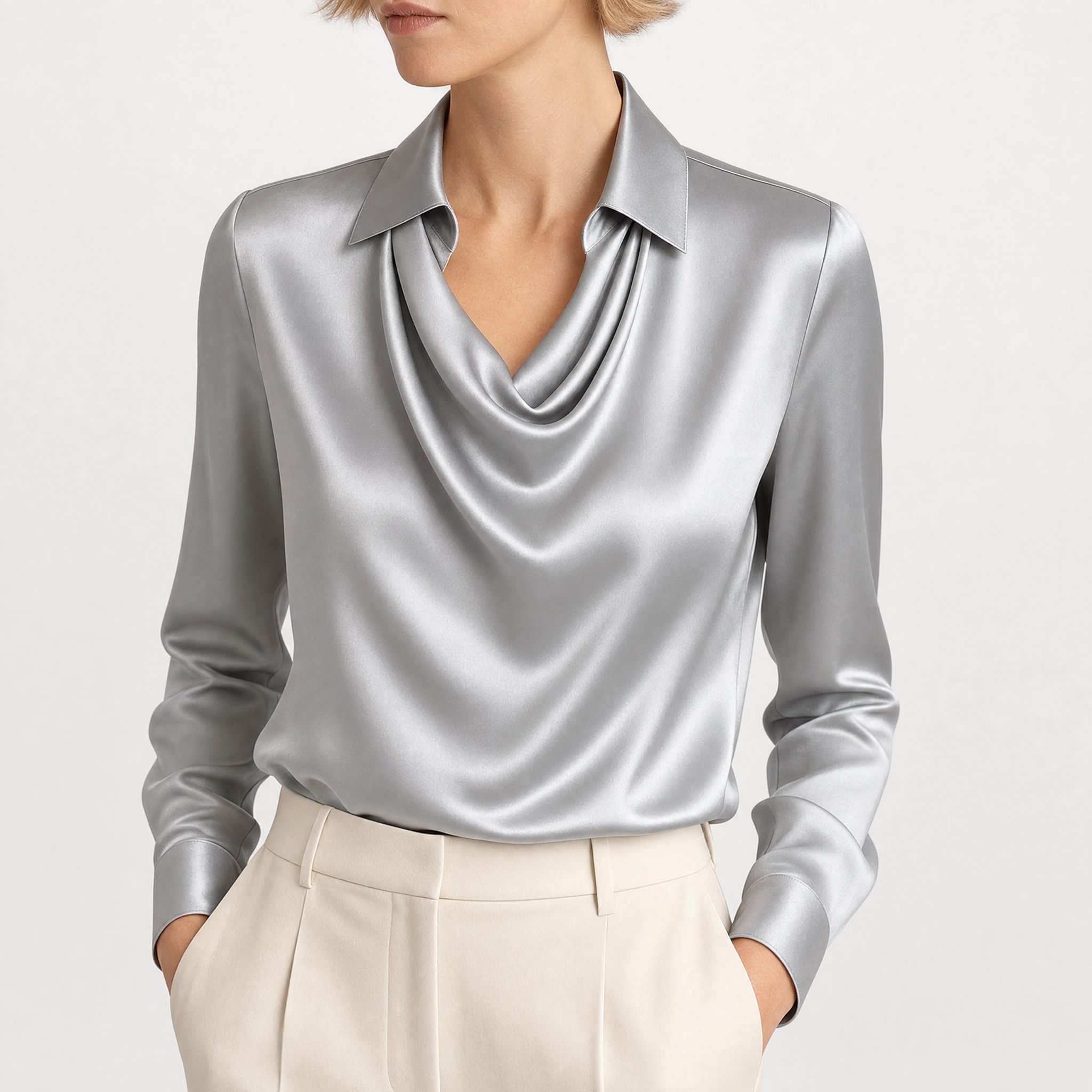 Model wearing gray draped neckline satin blouse with cream trousers