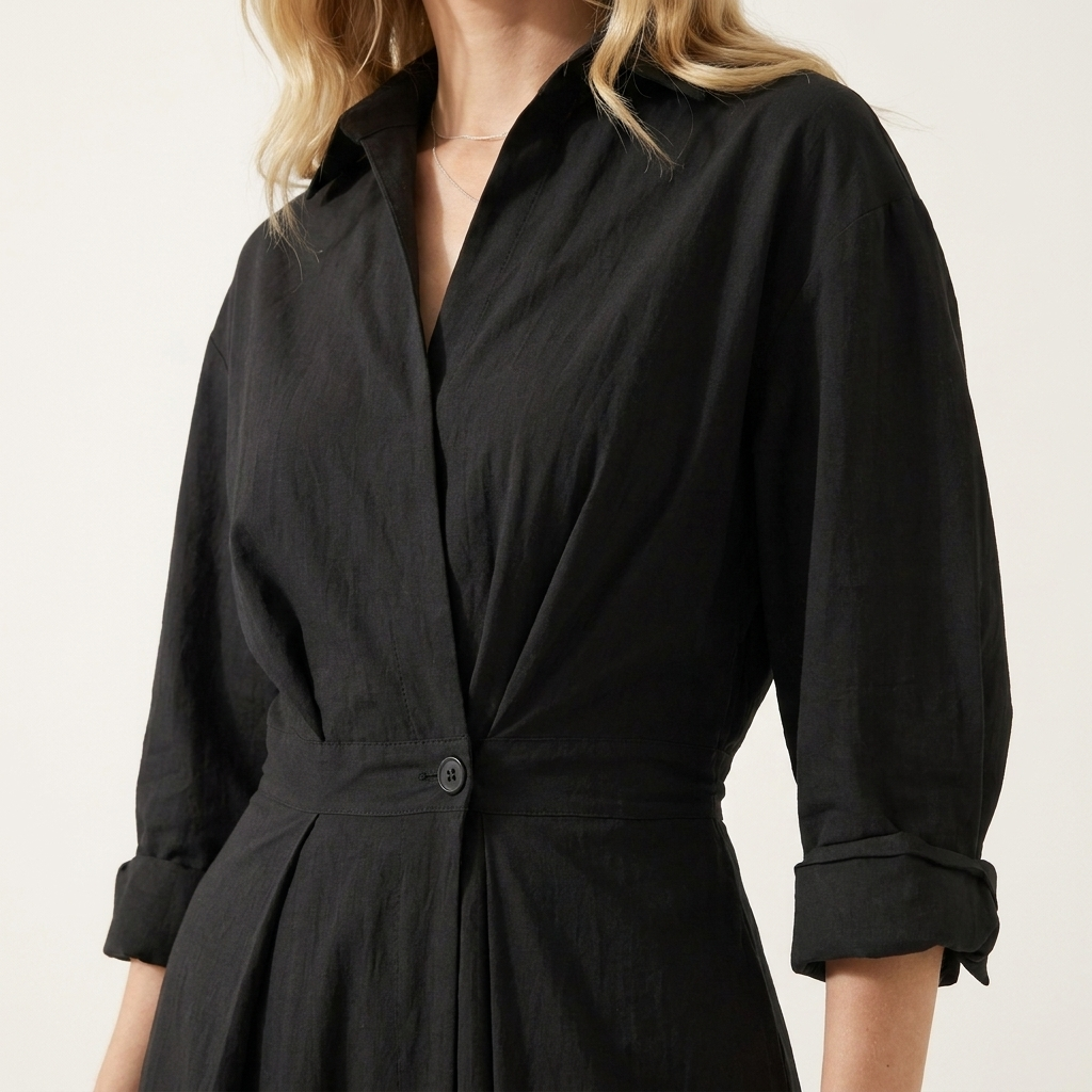 Close-up of the black dress collar, wrap front and single waist button