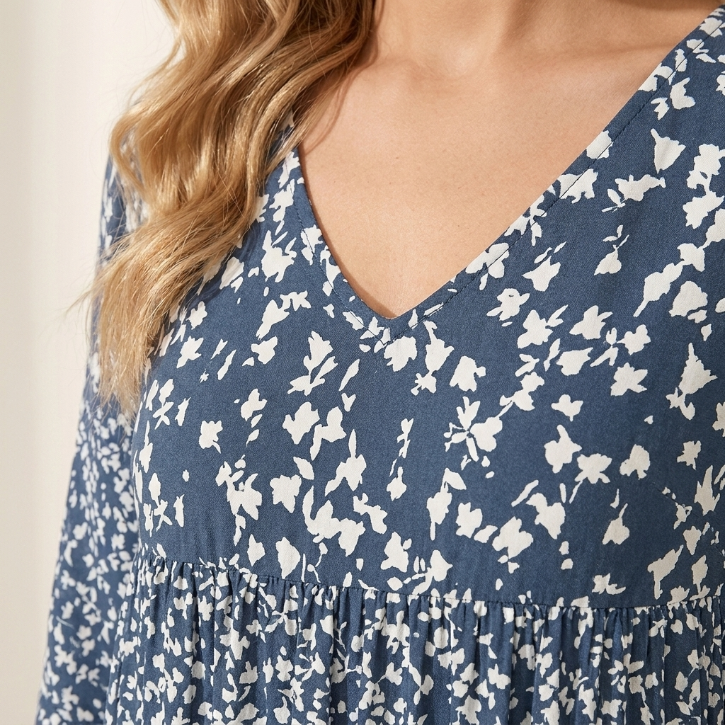 Close-up of the blue dress neckline and fabric texture showing seam detail