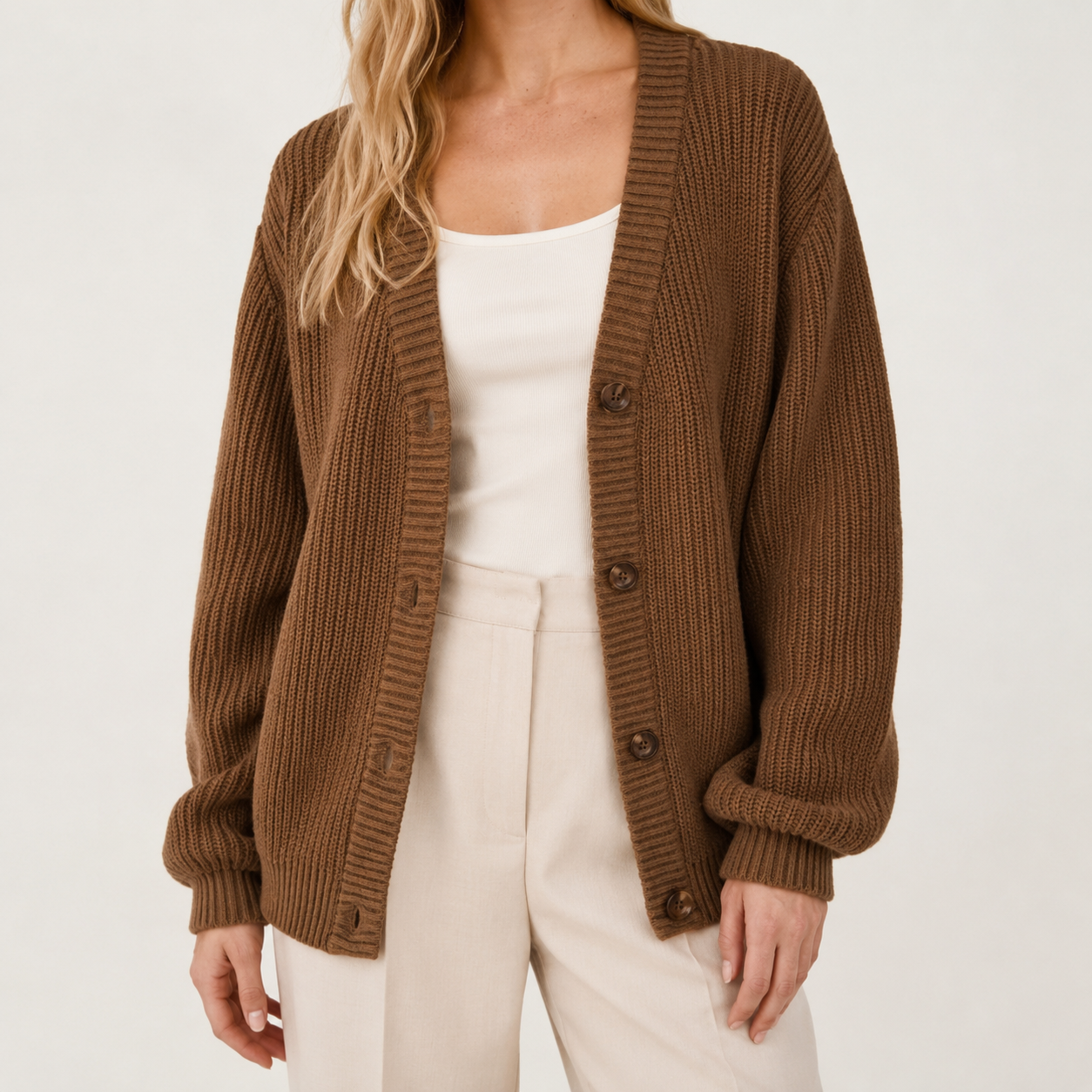Relaxed brown ribbed knit cardigan with a deep V-neck, button-through front, and comfortable dropped shoulders.