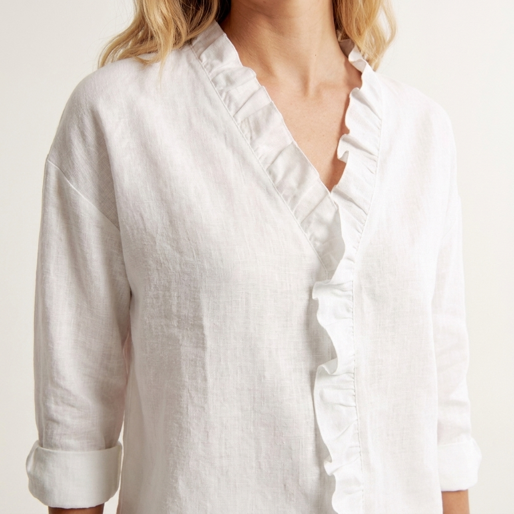 Close-up of the white blouse V-neckline ruffle detail