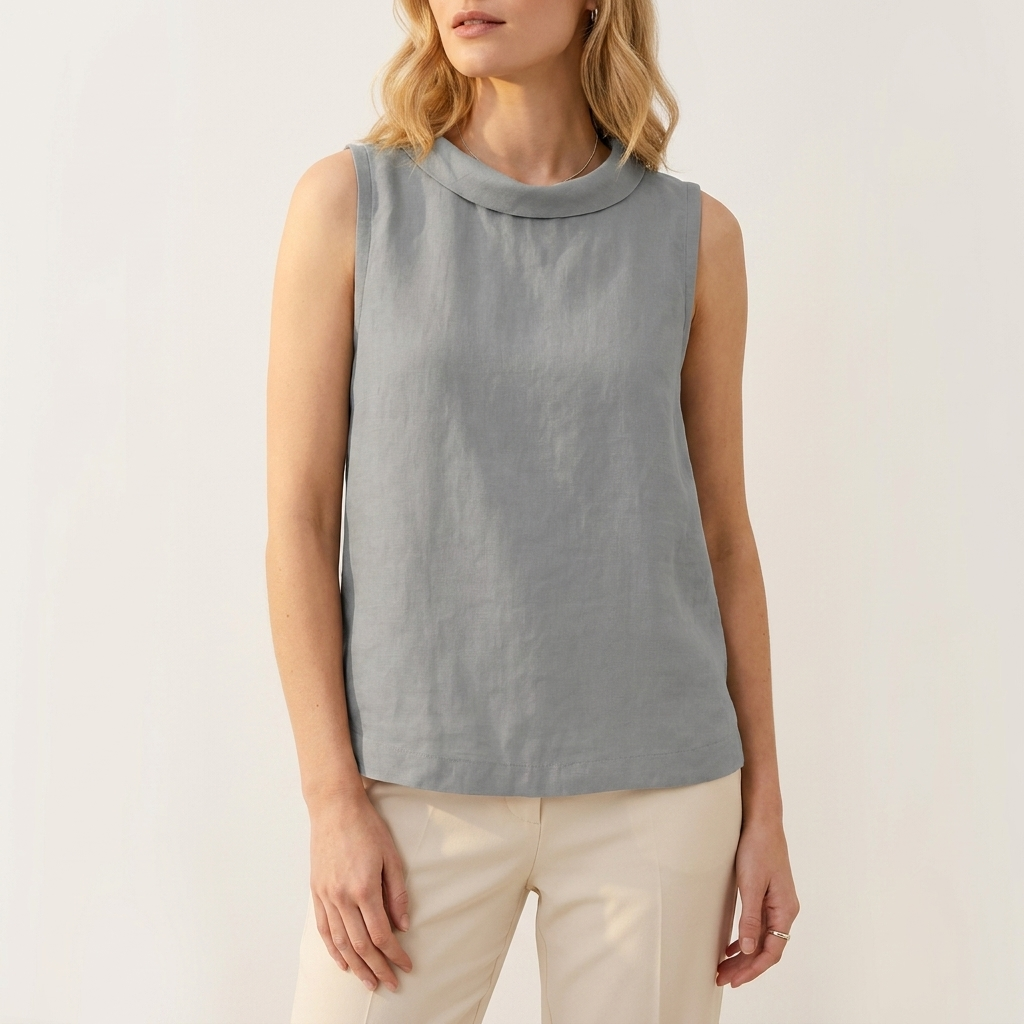 Woman wearing a gray sleeveless roll collar top, front studio view