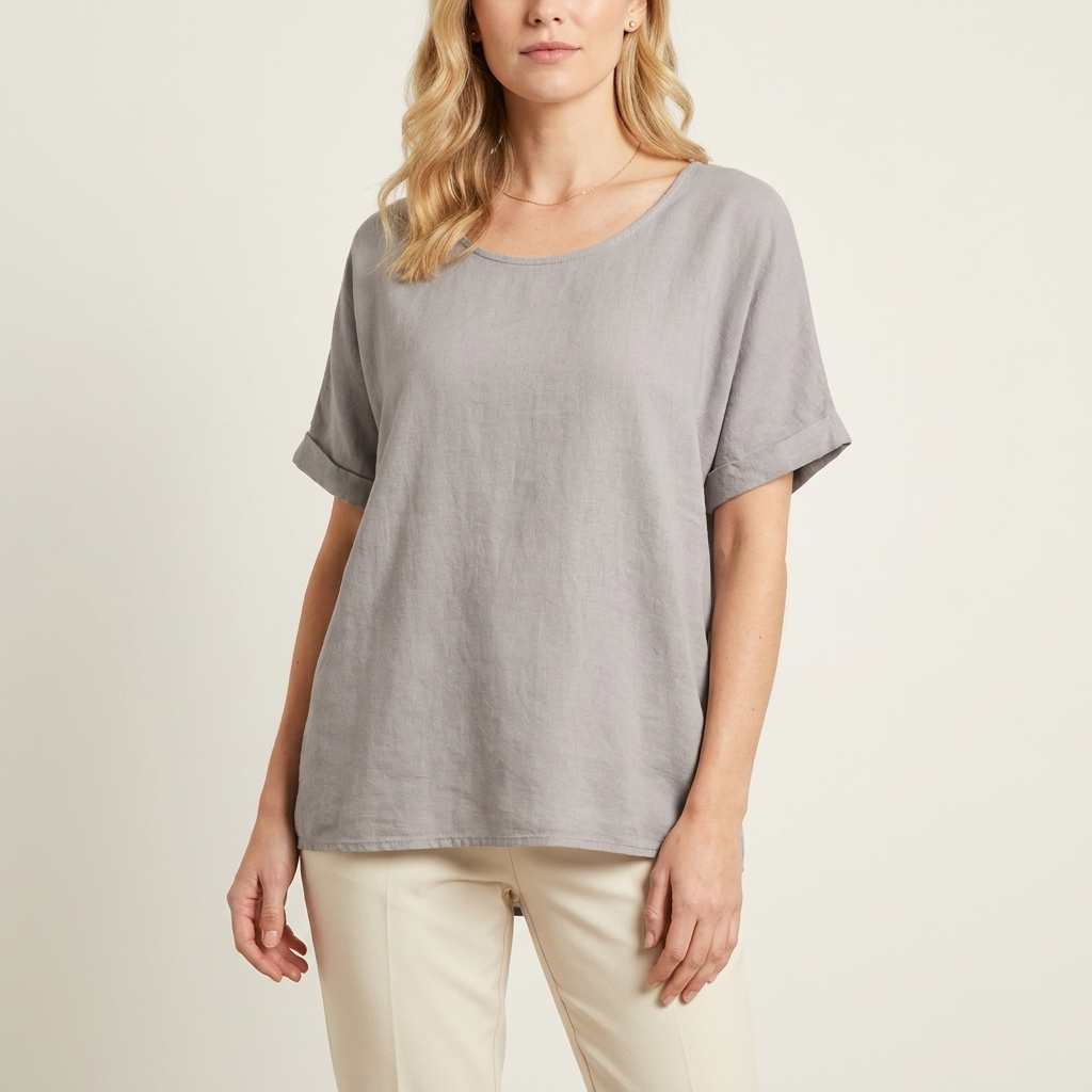 Woman wearing a grey loose-fit blouse with a relaxed silhouette, front studio view