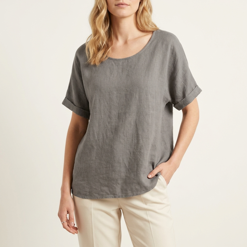 Woman wearing a dark grey loose-fit blouse with a relaxed silhouette, front studio view